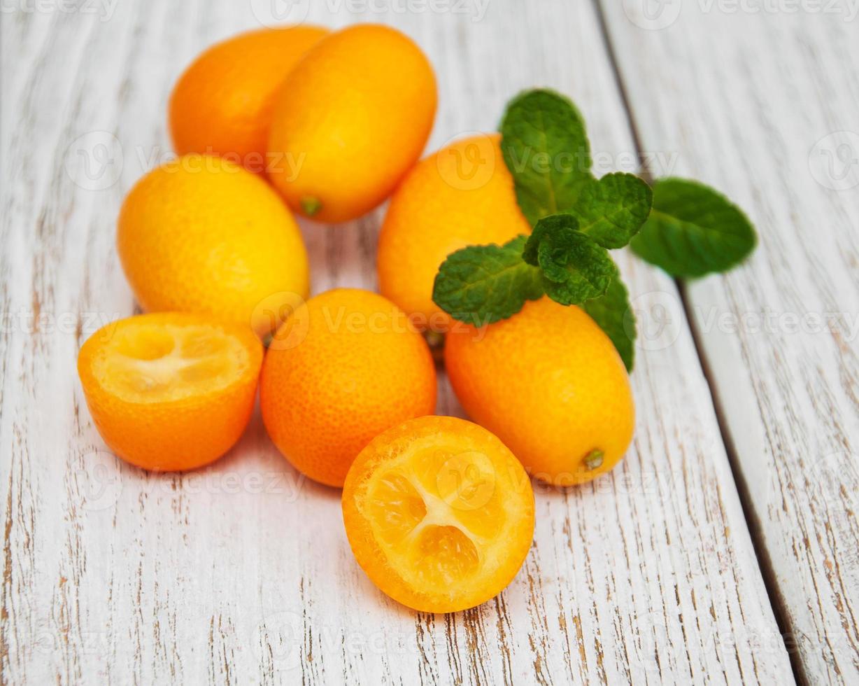 Kumquats on a wooden table photo