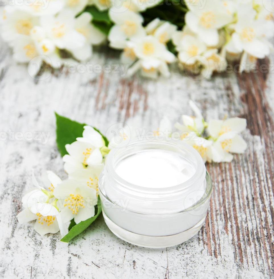 Moisturizing cream with jasmine flowers photo