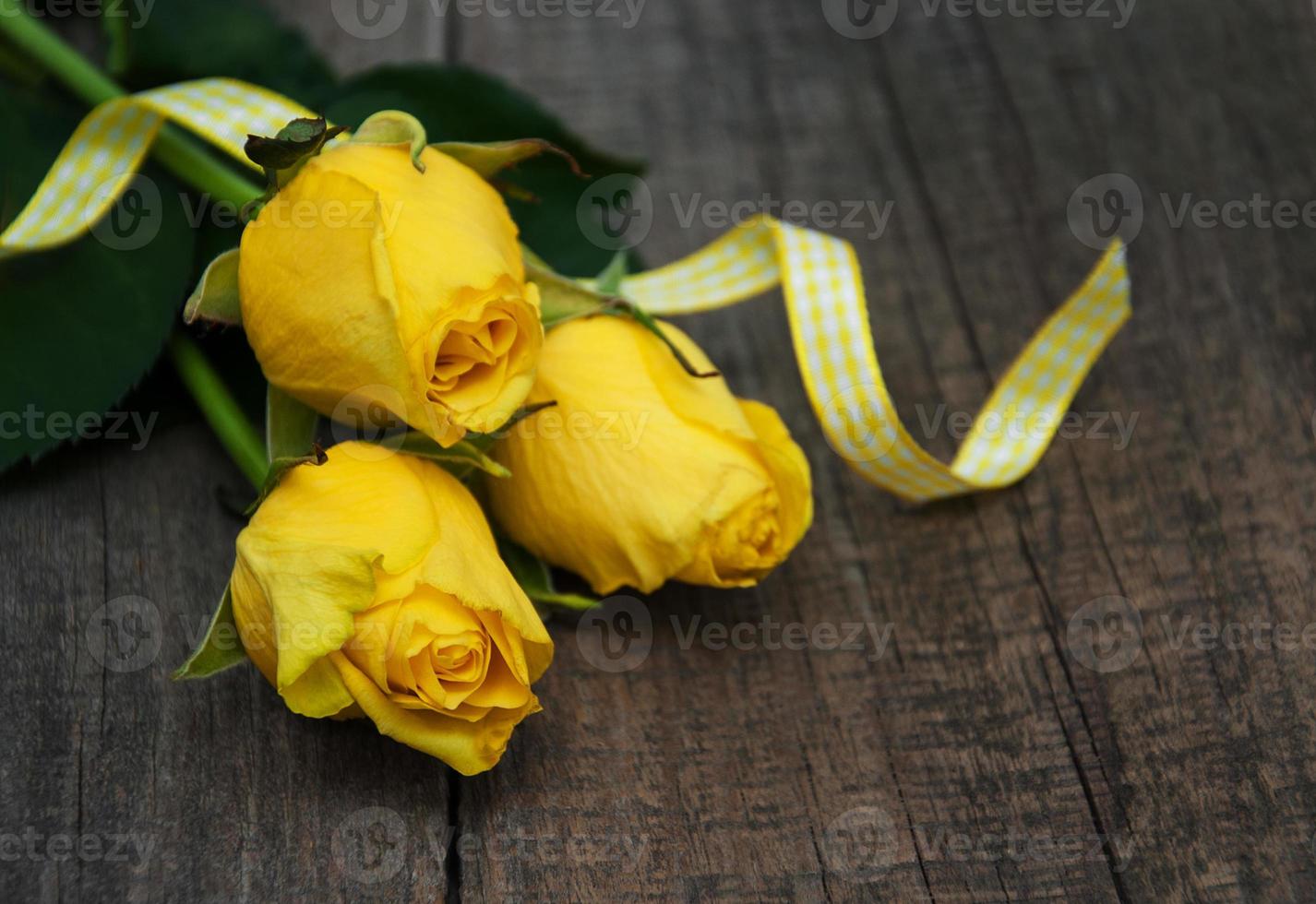 Yellow roses on a table photo