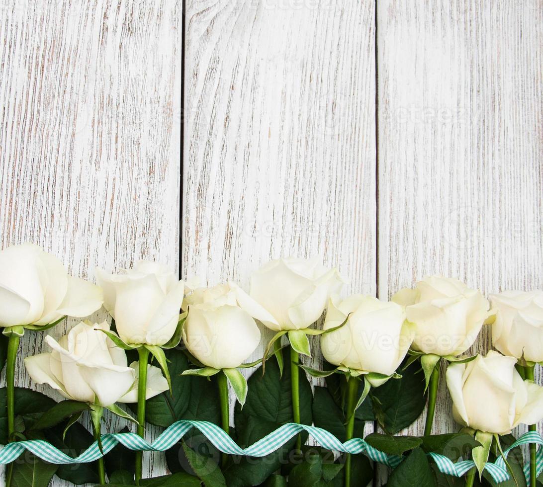 White roses on a wooden table photo