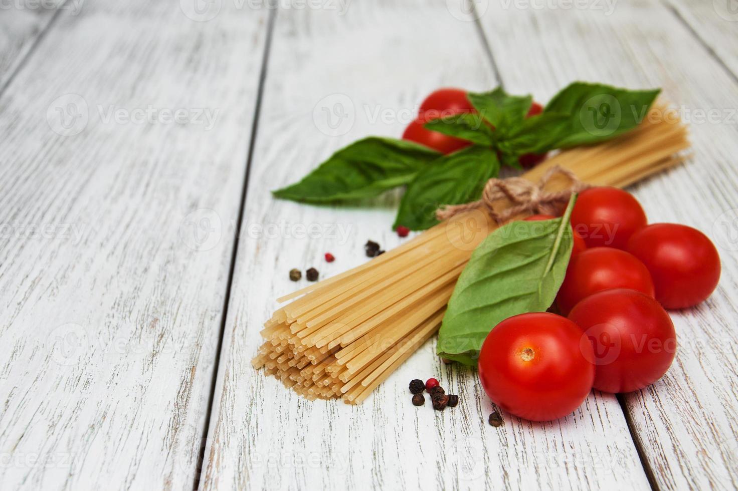 spaghetti, basil and tomatoes photo