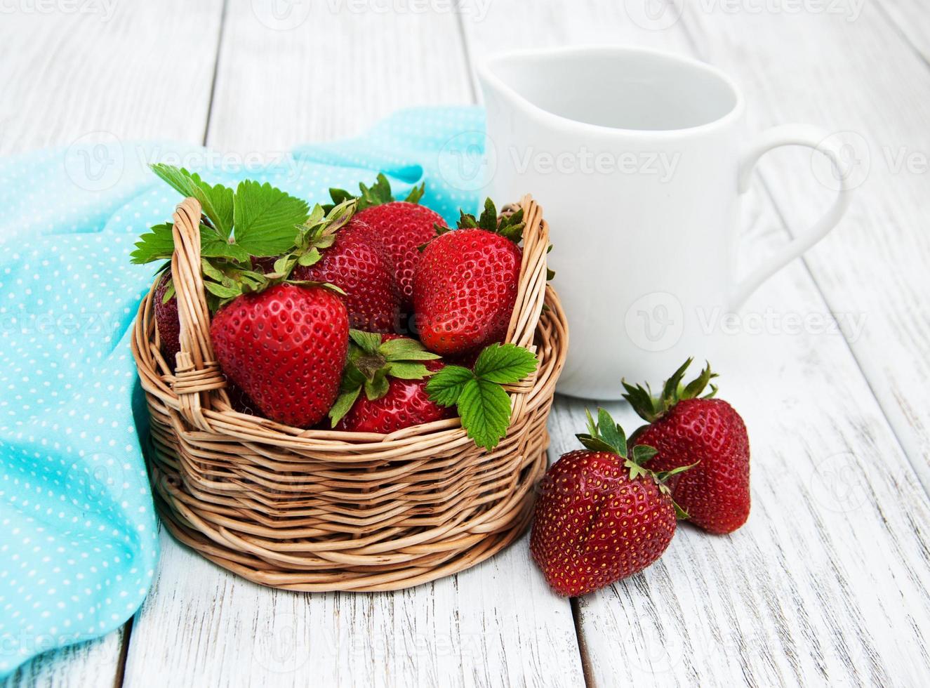 ripe strawberries on wooden table photo