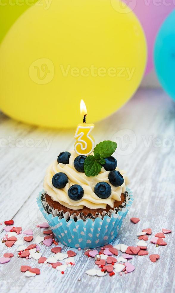 Cupcake with a numeral three candle photo