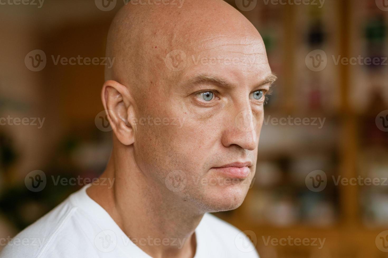 The man looks into the distance against the background of the room. photo