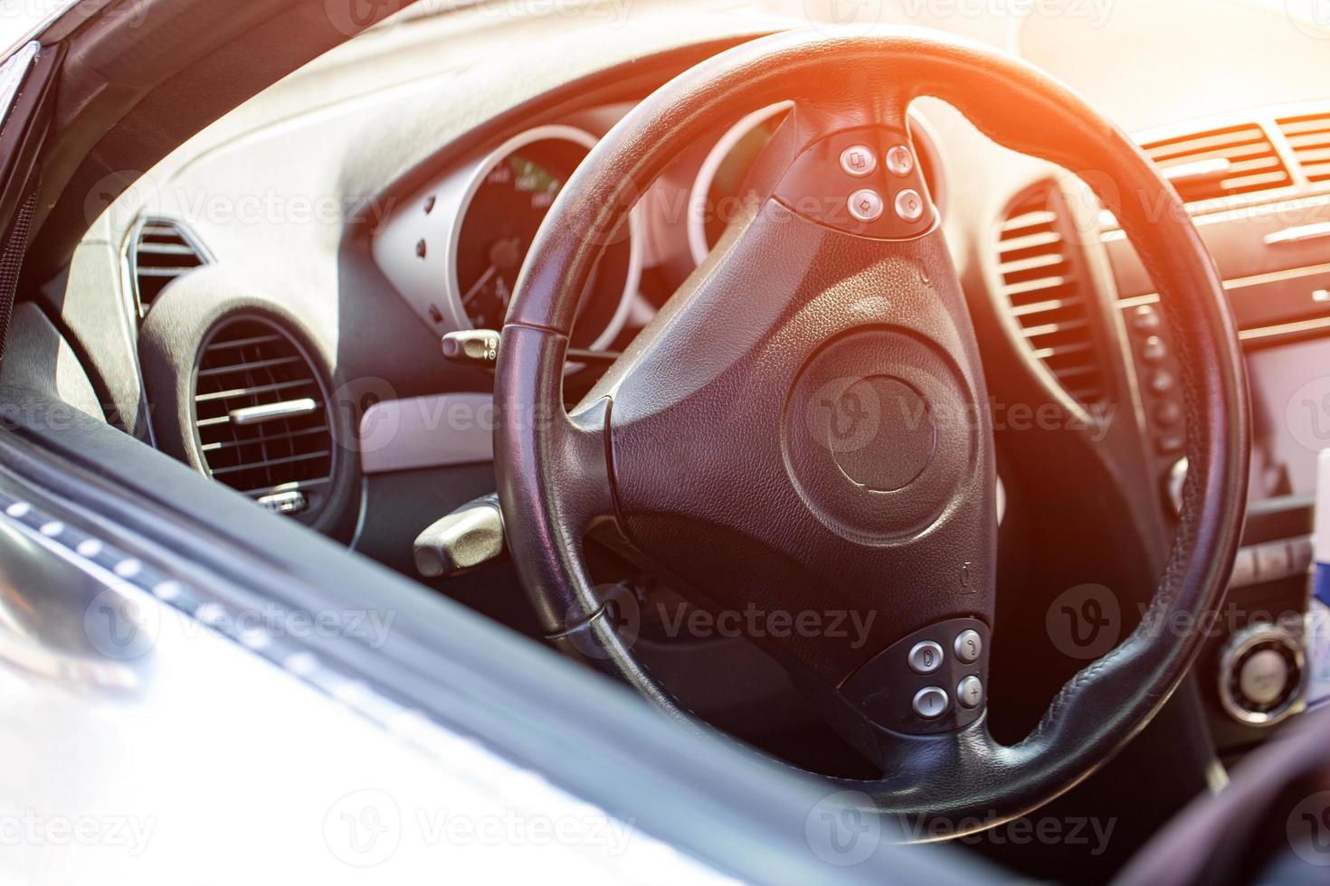 Leather black steering wheel in the car photo