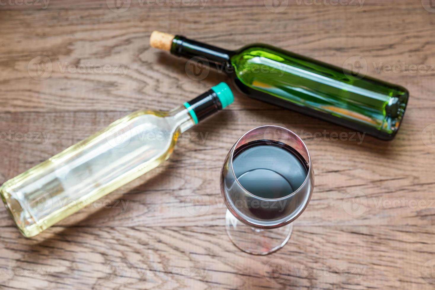Glasses and bottles with red and white wine photo