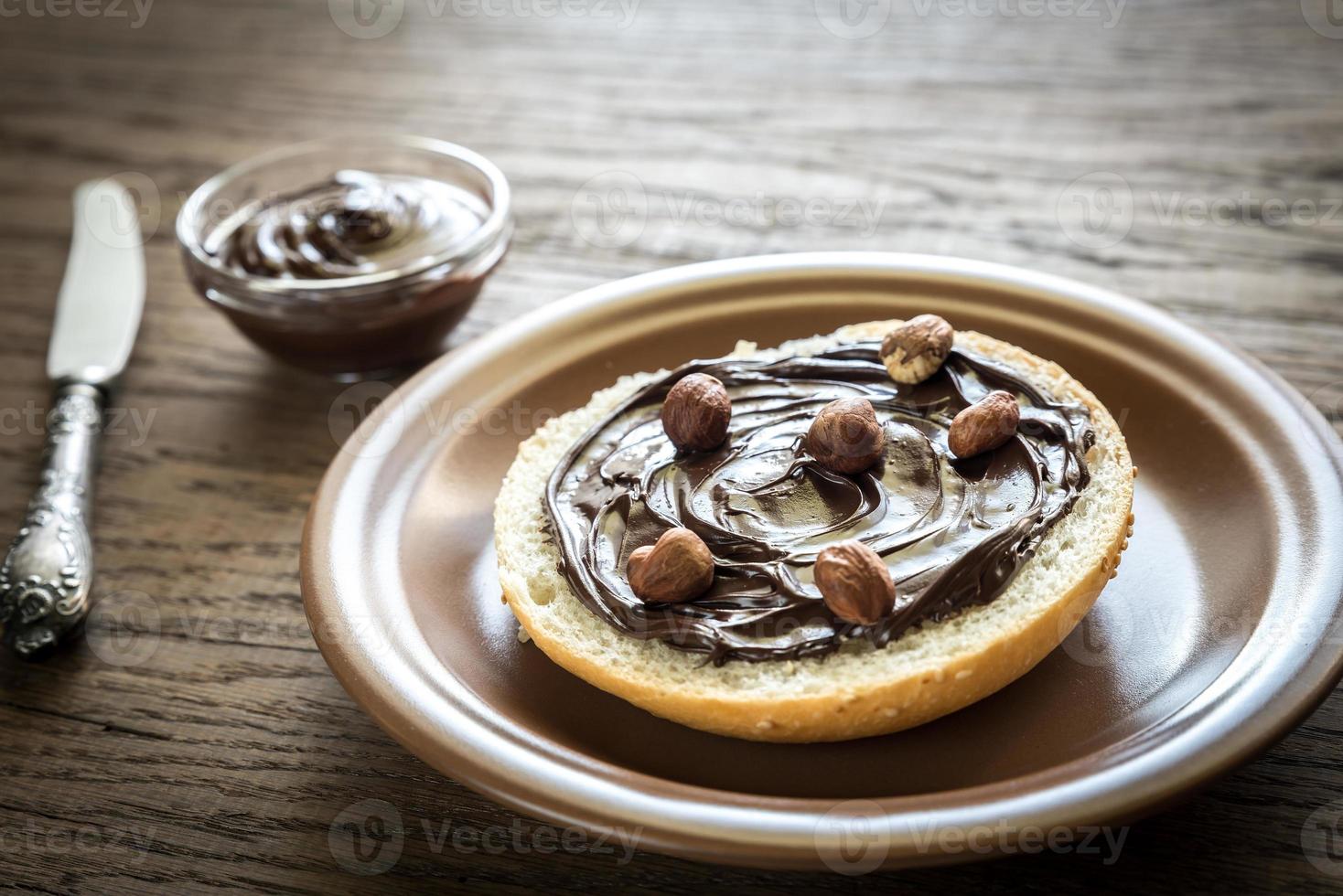 Seasame bun with chocolate cream and nuts photo