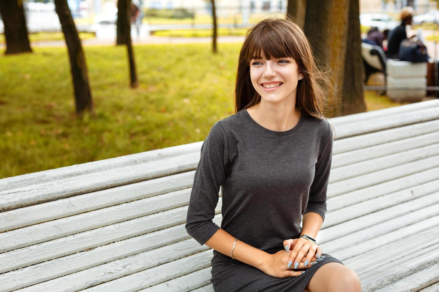 portrait of a young woman sitting in the Park on a bench photo