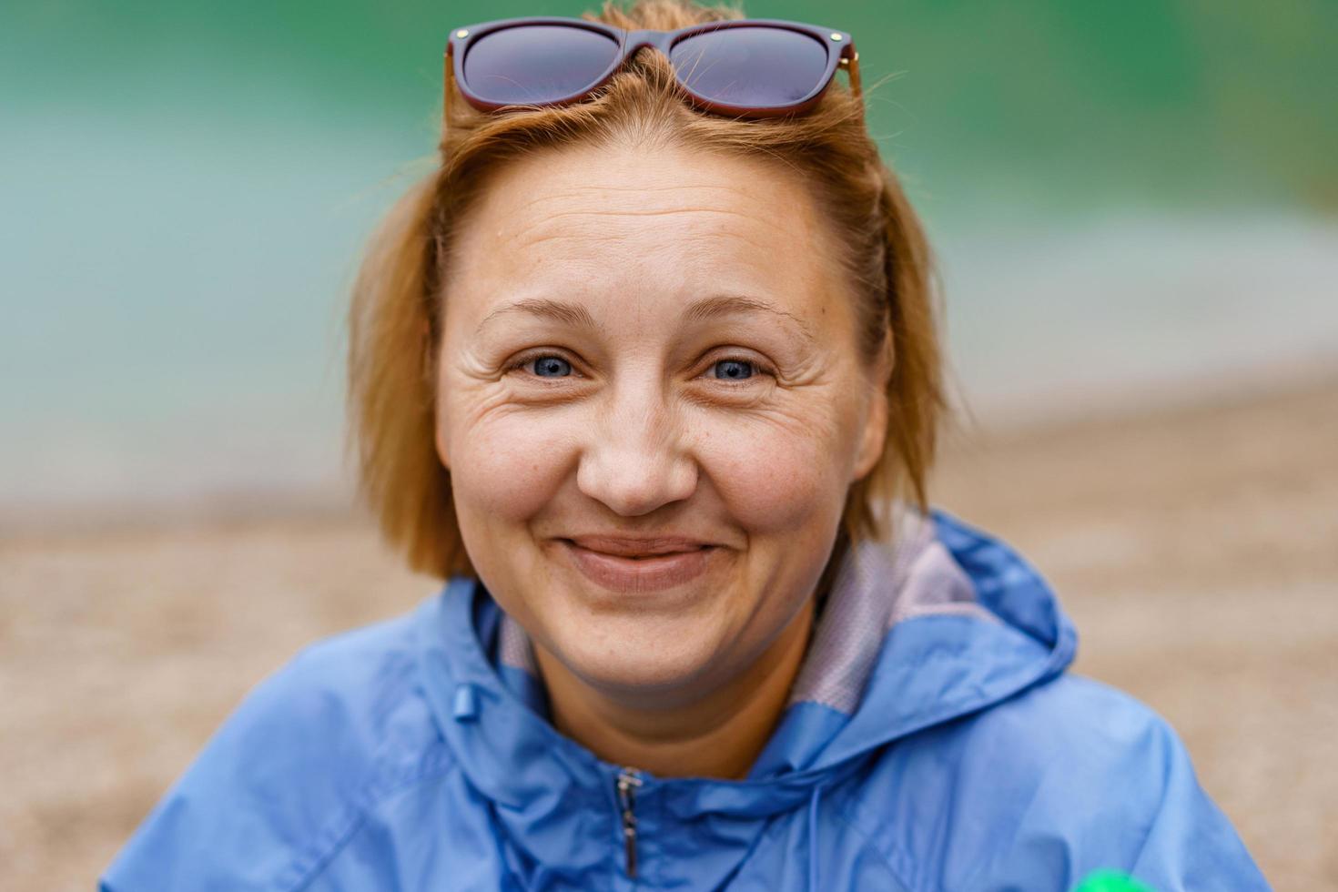 Autumn woman portrait. Caucasian woman smiling happy in blue jacket outside photo