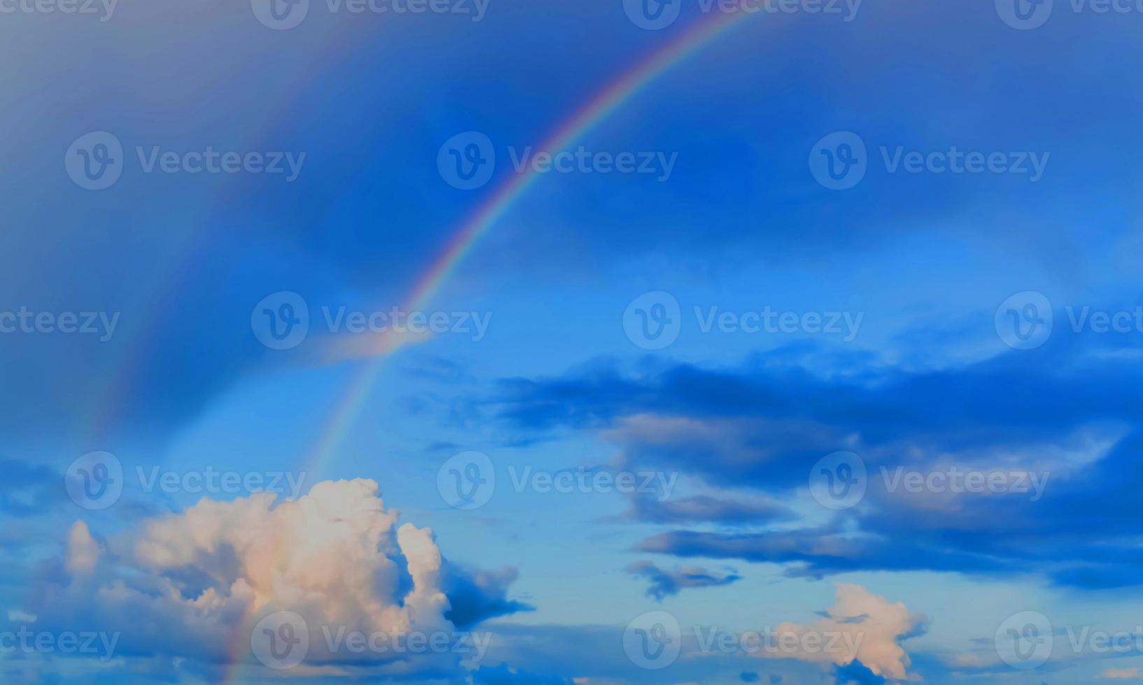 rainbow sky with some white clouds surface abstract flow thunder clouds in the light blue sky. photo