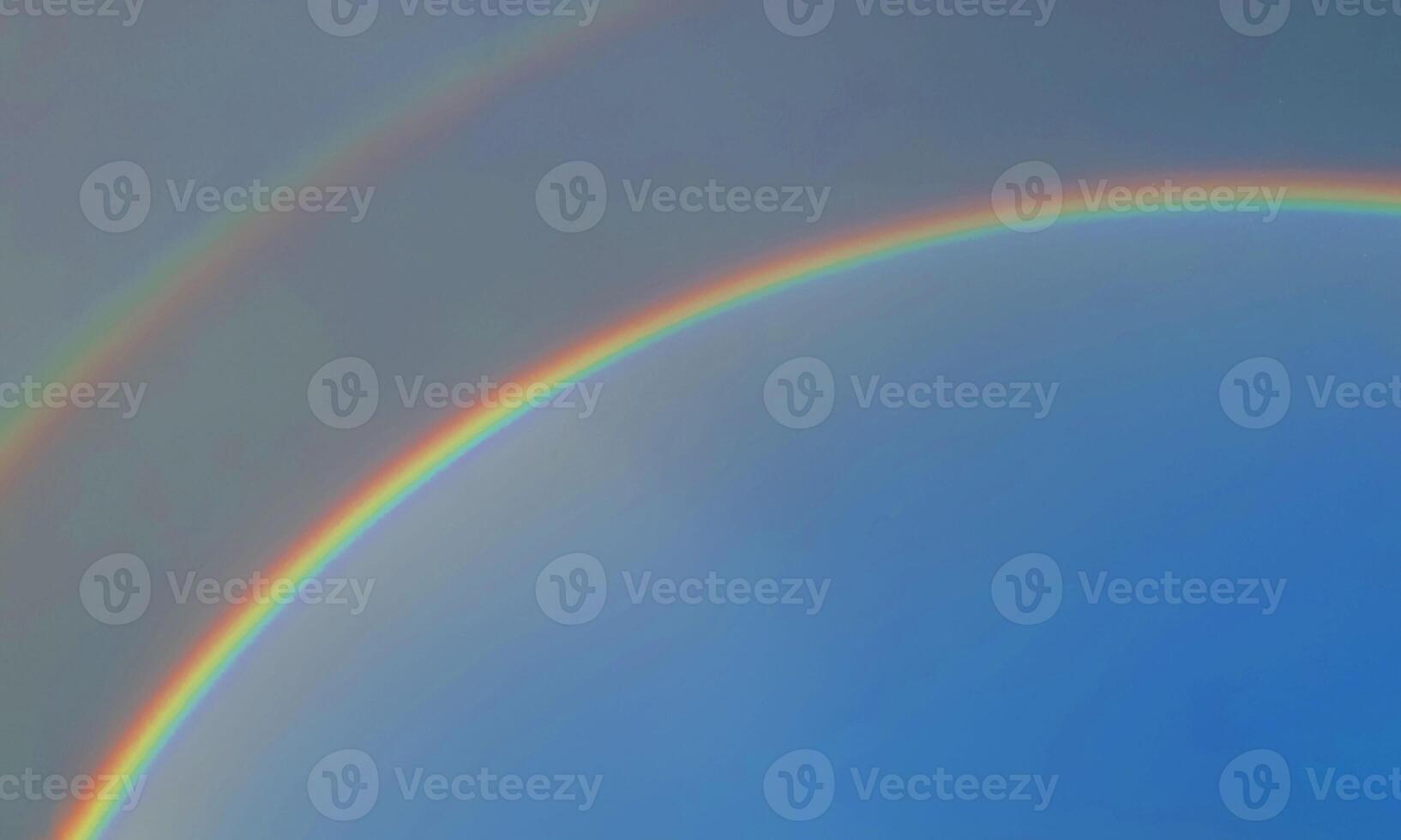 rainbow sky with some white clouds surface abstract flow thunder clouds in the light blue sky. photo