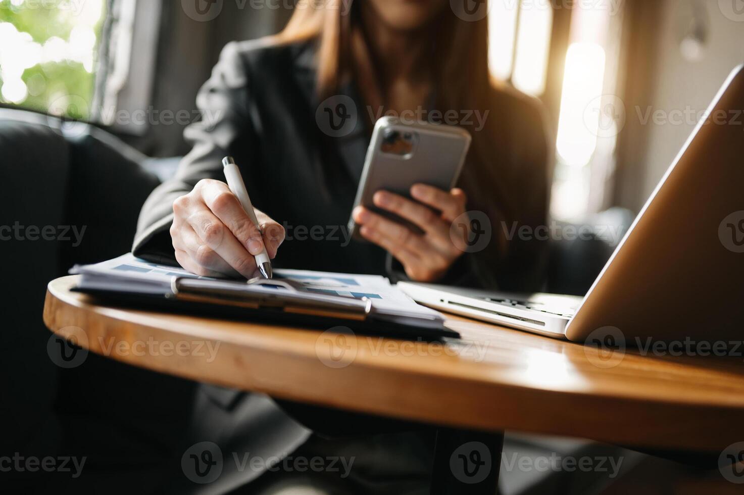Woman using smart phone for mobile payments online shopping,omni channel,sitting on table photo