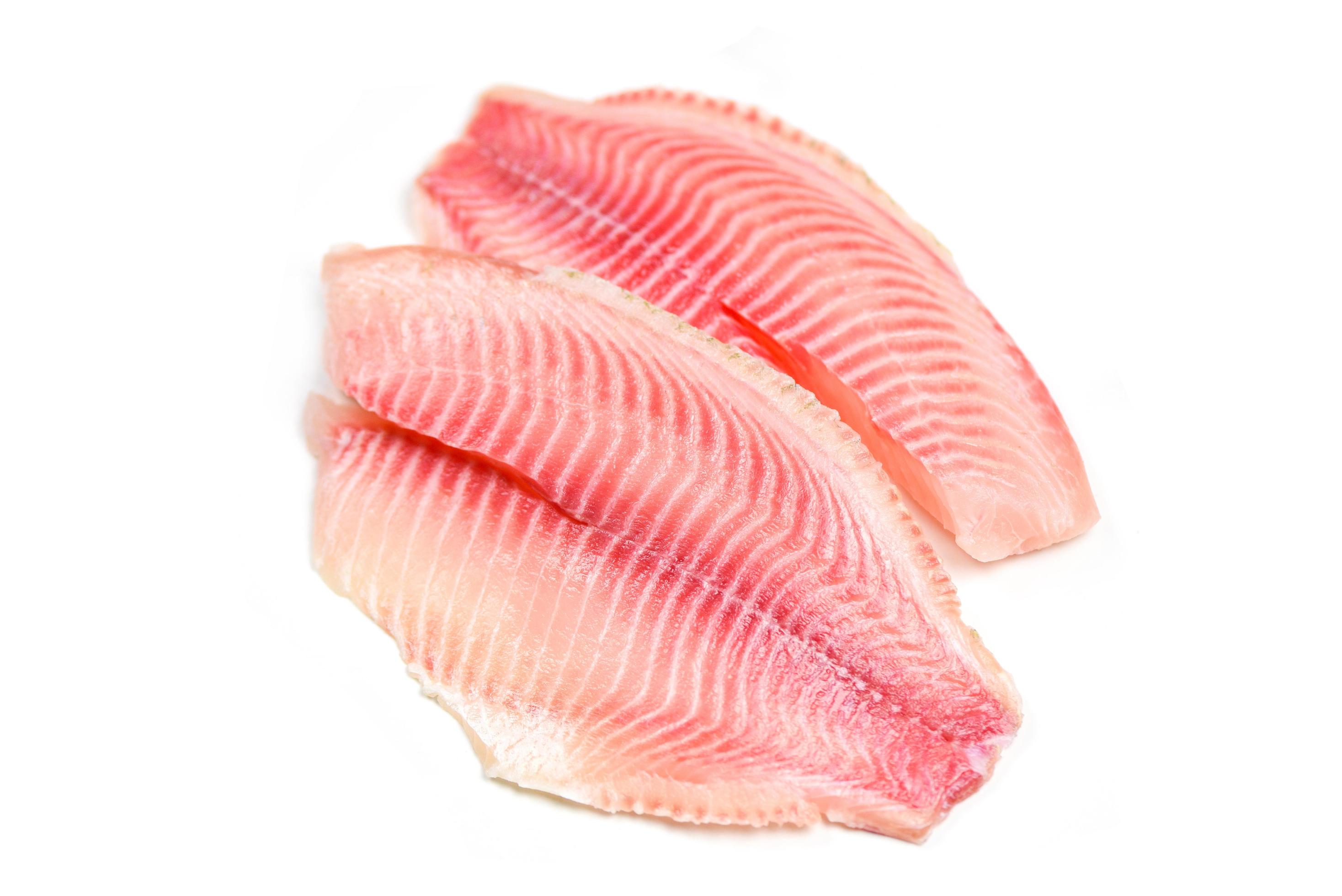 Fresh fish fillet sliced for steak or salad Raw tilapia fillet fish