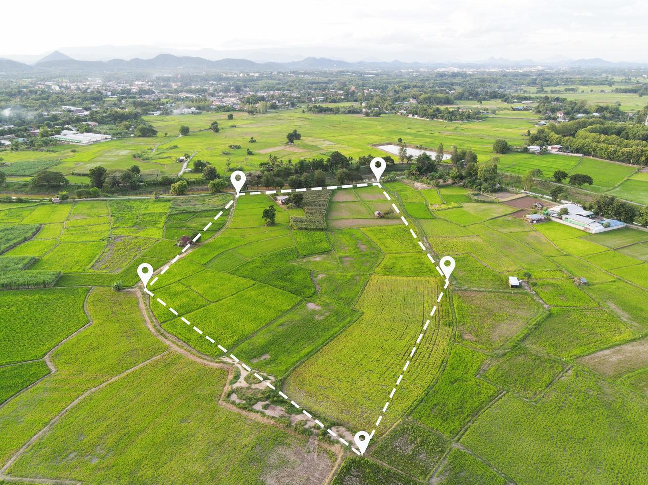 Land plot in aerial view, Top view land green field agriculture plant with pins, pin location icon for housing subdivision residential development owned sale rent buy or investment countryside suburbs photo