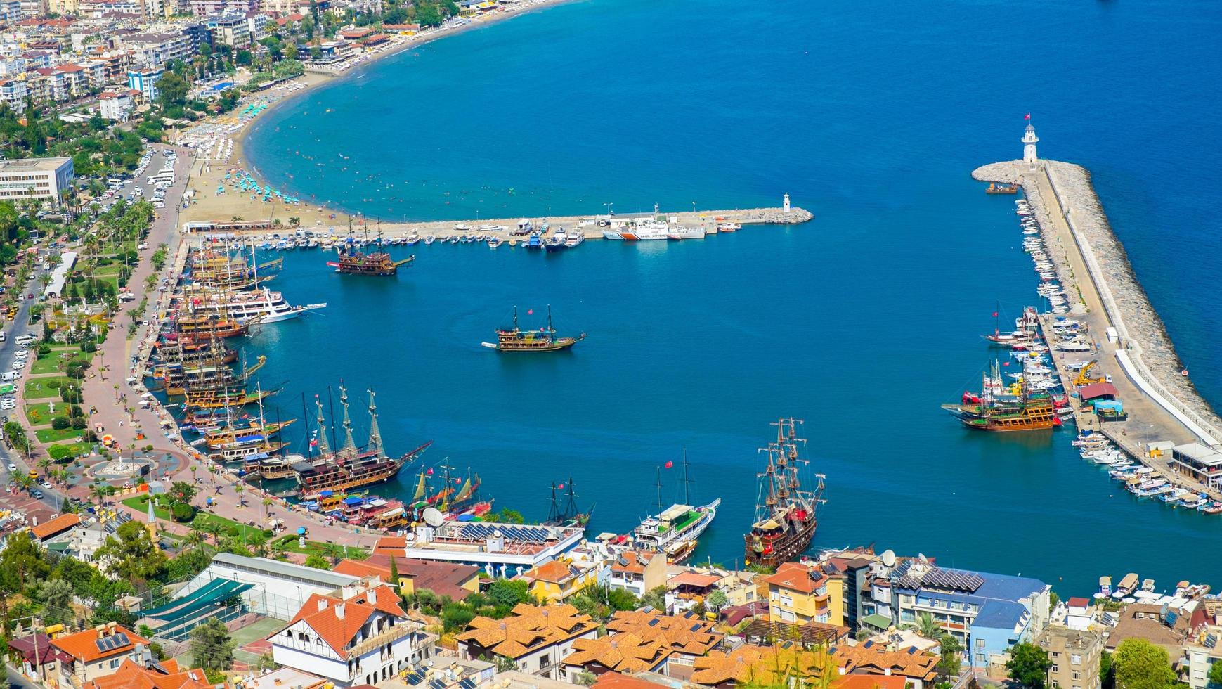 Alanya beach top view on the mountain with coast ferry boat on blue sea and harbor city background - Beautiful cleopatra beach Alanya Turkey landscape travel landmark photo