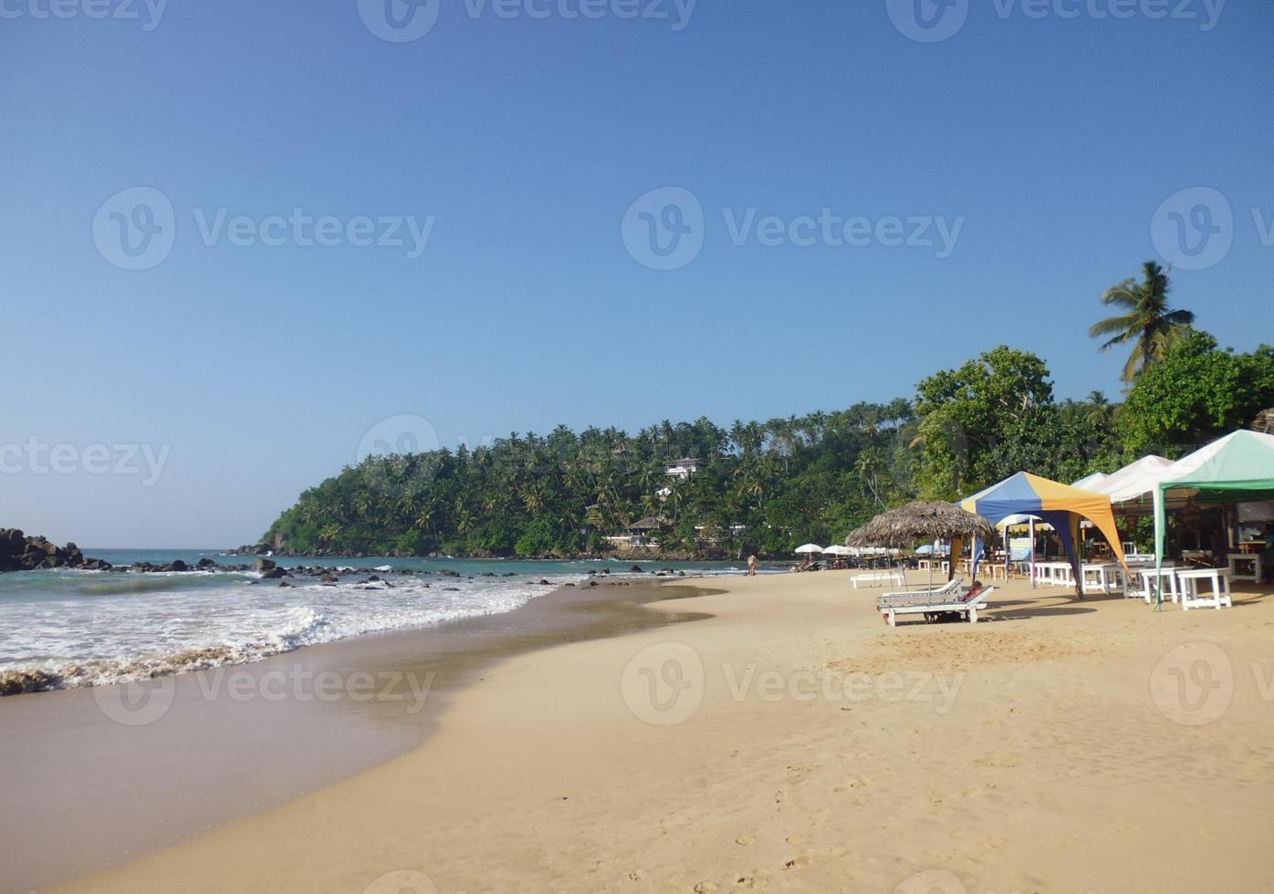 Beach with sun loungers in a quiet lagoon photo