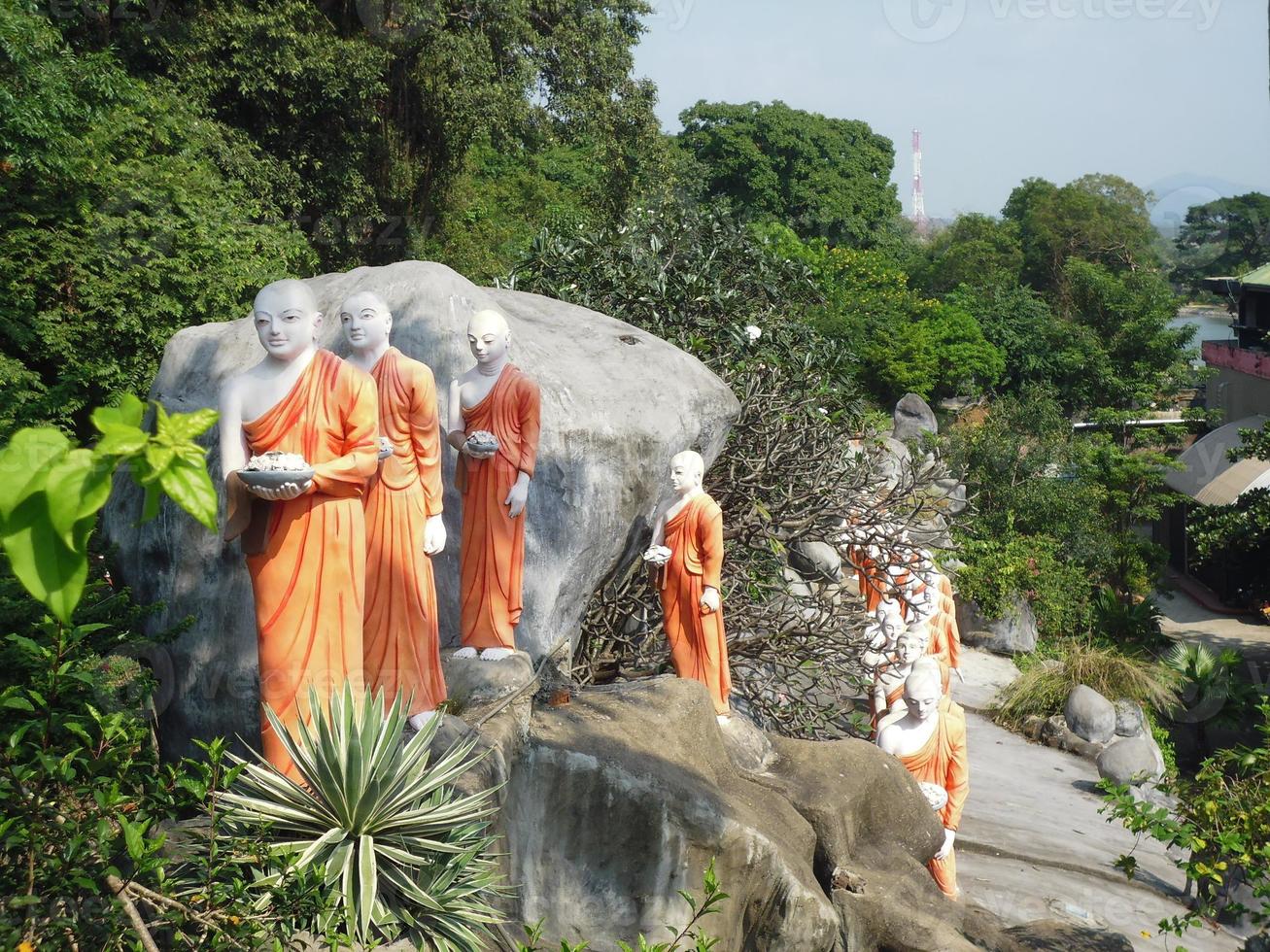 the statue of a string of monks near a temple in Dambulla Sri Lanka photo