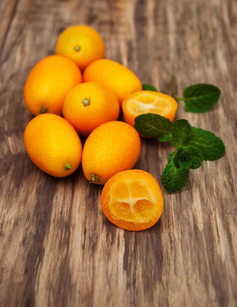 Kumquats on a wooden table photo