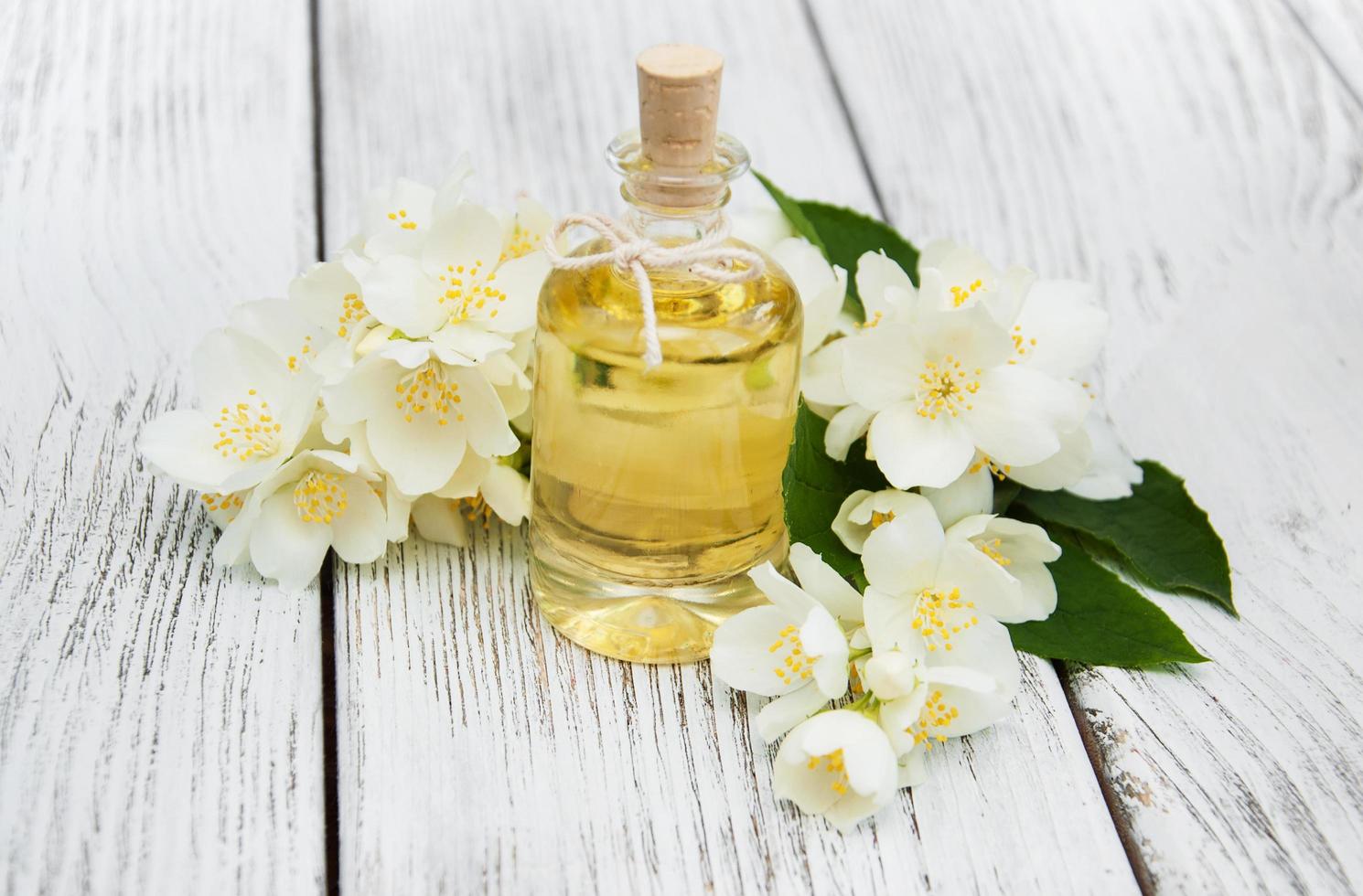 Massage oil with jasmine flowers photo