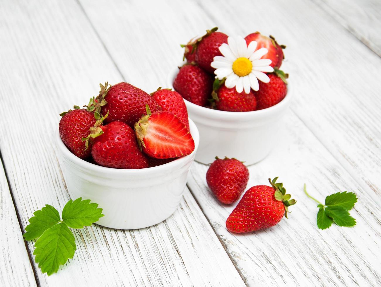 ripe strawberries on wooden table photo