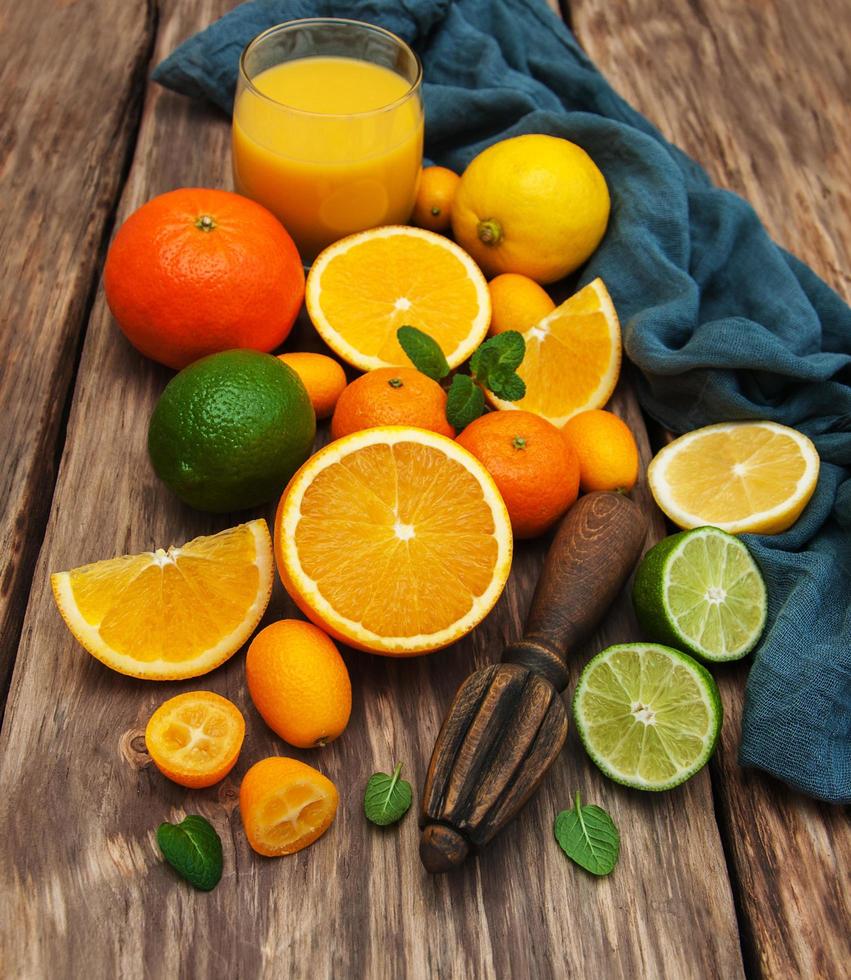 Fresh citrus fruits and old juicer photo