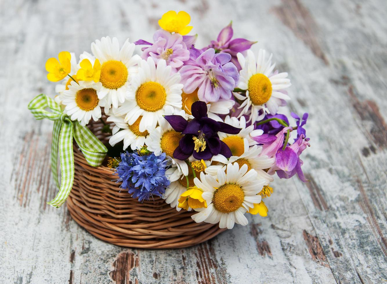 Basket with wild flowers photo