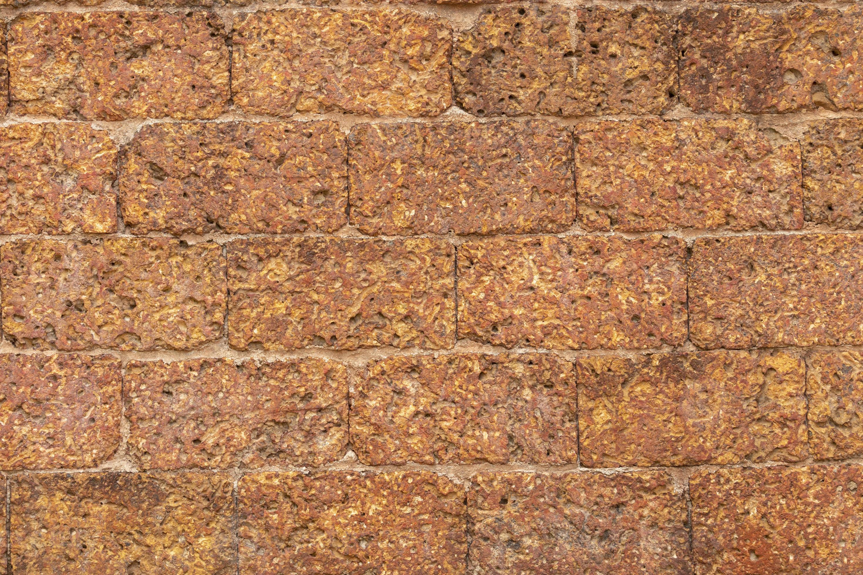 blur of red laterite brick wall Porous and finegrained Background