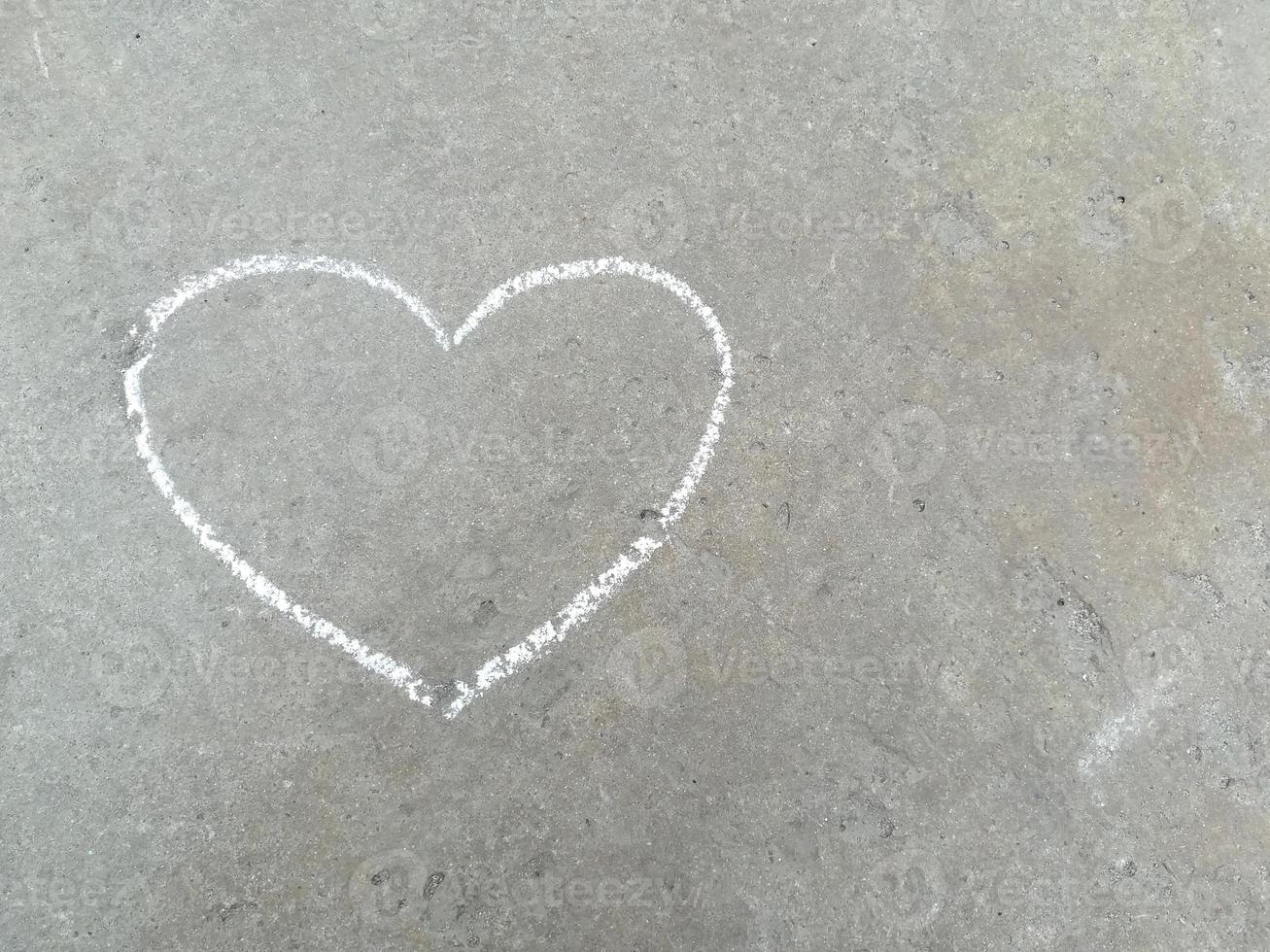 heart - white chalk hand drawing on black asphalt photo