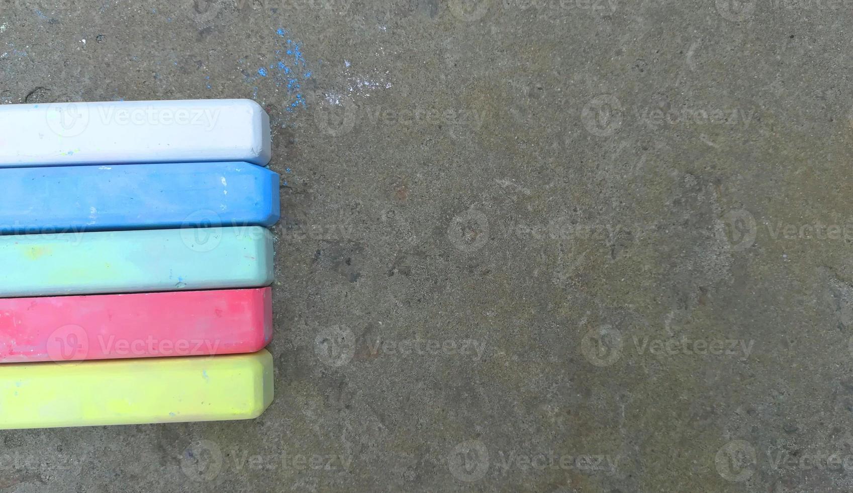 multi-colored crayons lie on the asphalt. fun summer game. children drawing, creativity, banner, place for text, copy space photo
