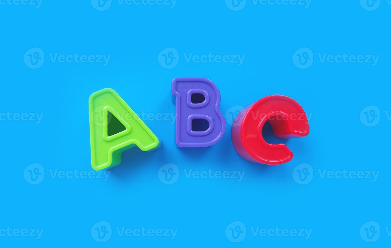 abc letters isolated on blue background. banner, alphabet brightly toy, learning. photo