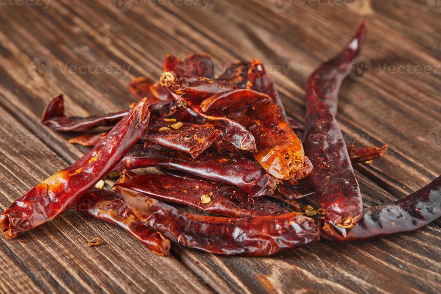 Dried red hot pepper on wooden vintage background photo