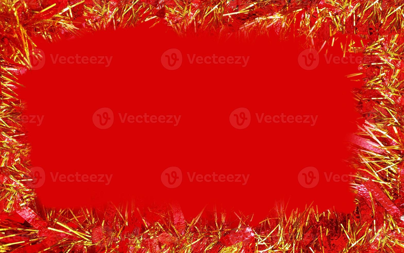 red and gold shiny Christmas decoration on a red background. christmas greeting card. horizontal border frame with place for text copy space photo
