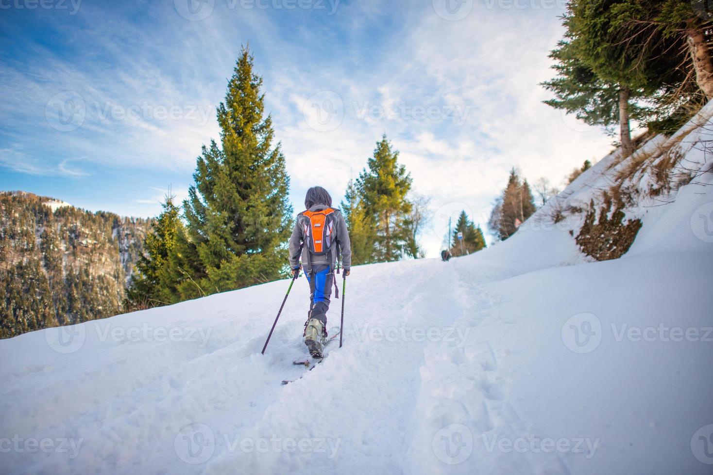 A child with ski touring uphill photo