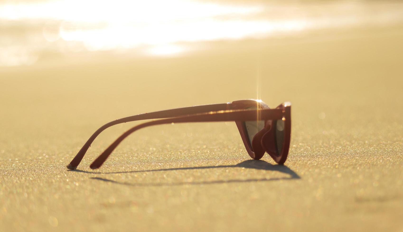 sunglasses on sand beautiful summer beach copy space Holiday concept. photo