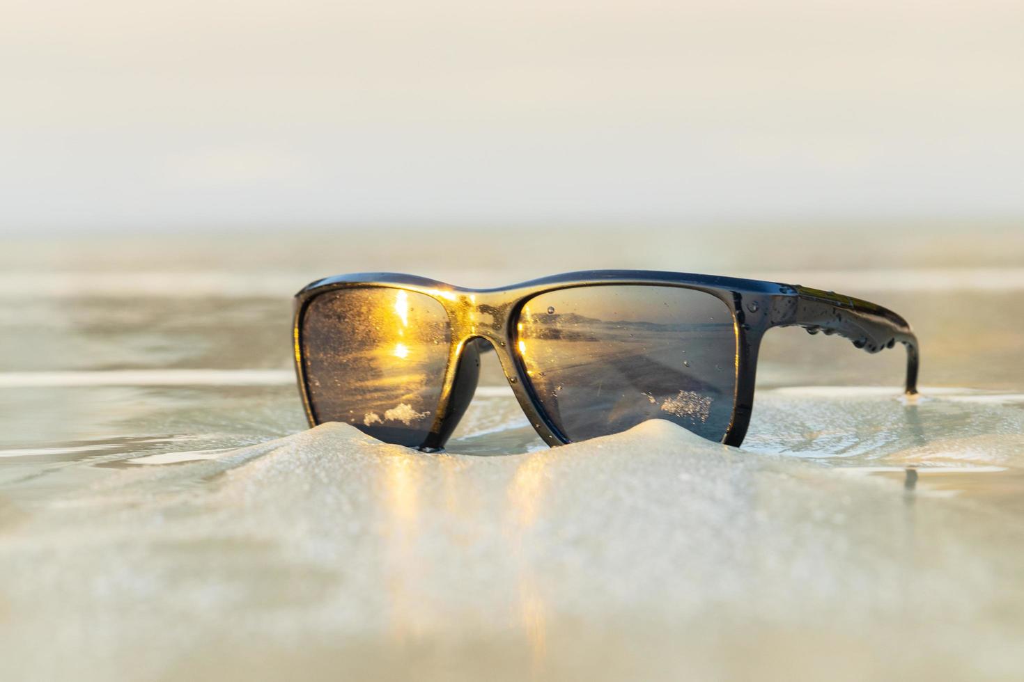 Sunglasses on sand beautiful summer beach photo