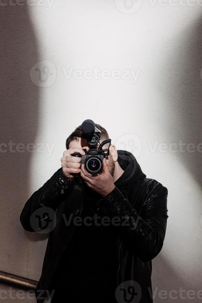 stylish man holds a video camera photo