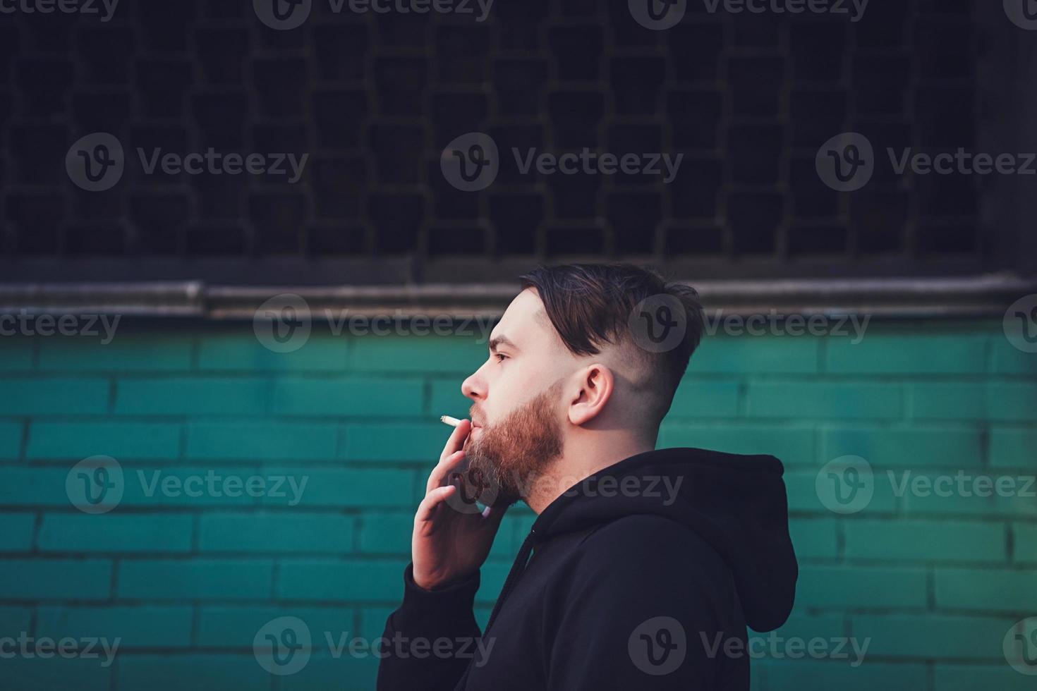 handsome man smoking cigarette photo