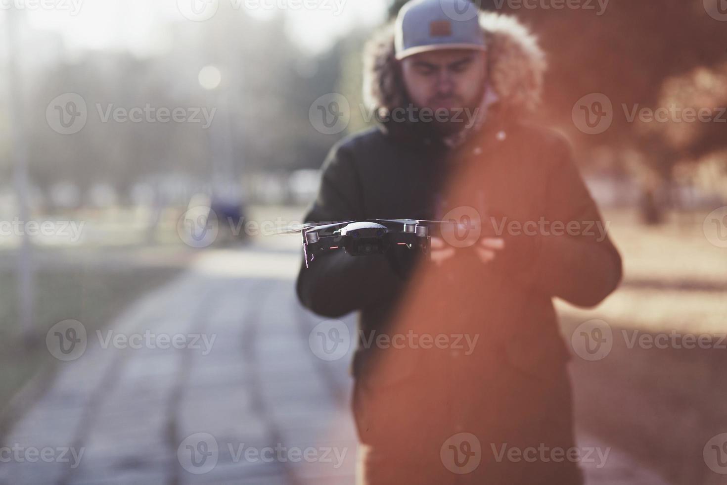 man with flying drone photo