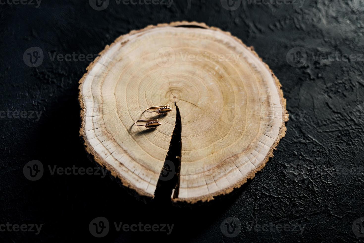 gold earrings on wood photo