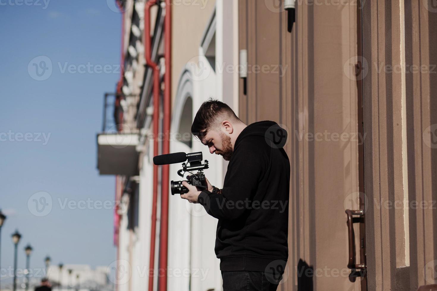 operator with a camera shoots a report photo