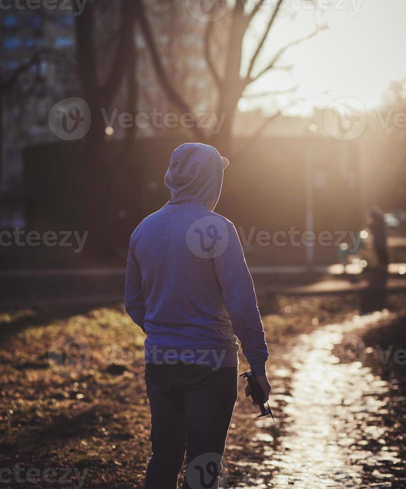 man in hood with a drone photo