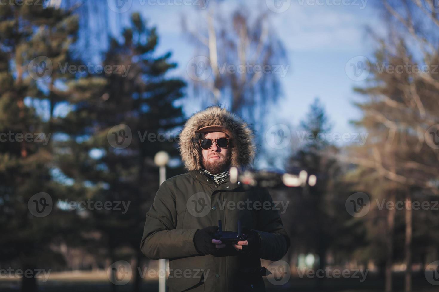 Man operating drone flying photo