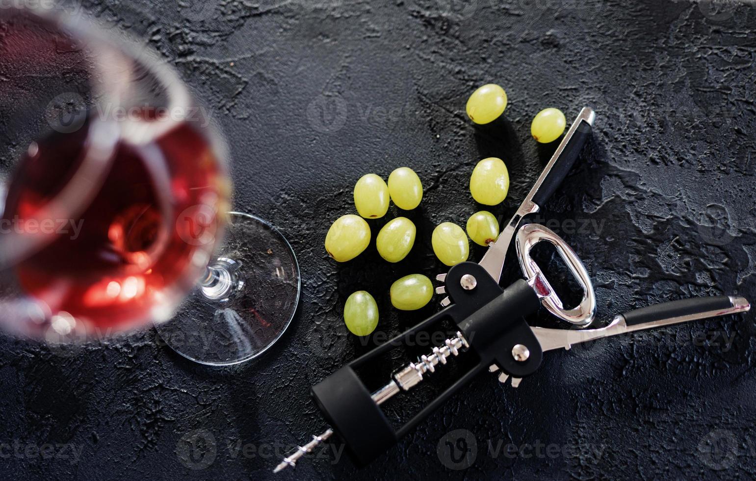 black corkscrew and grapes photo