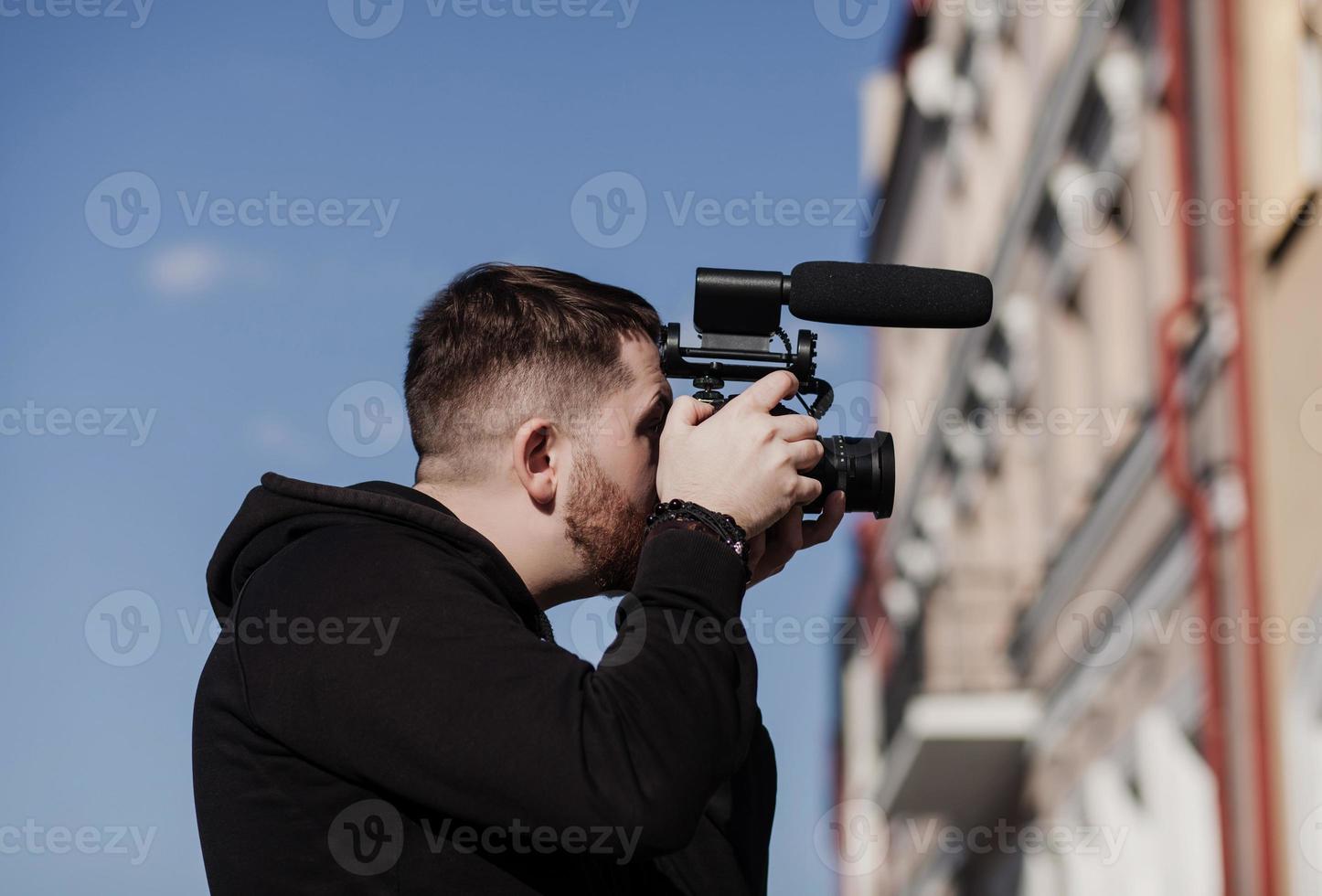 man with a camera makes a report photo