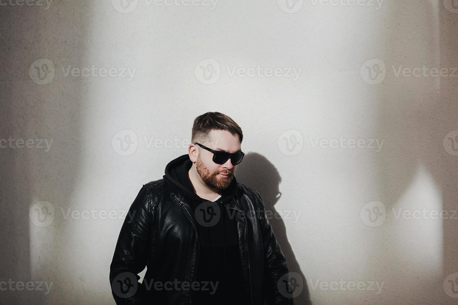 bearded man wearing leather jacket photo