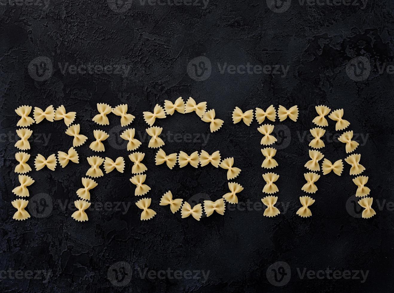 Word pasta on dark background. photo