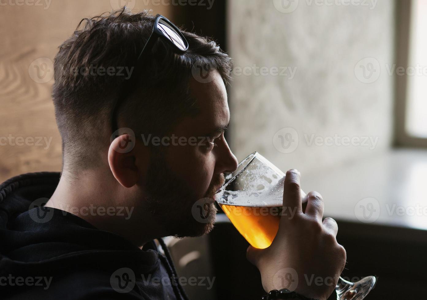 handsome man drinks beer photo