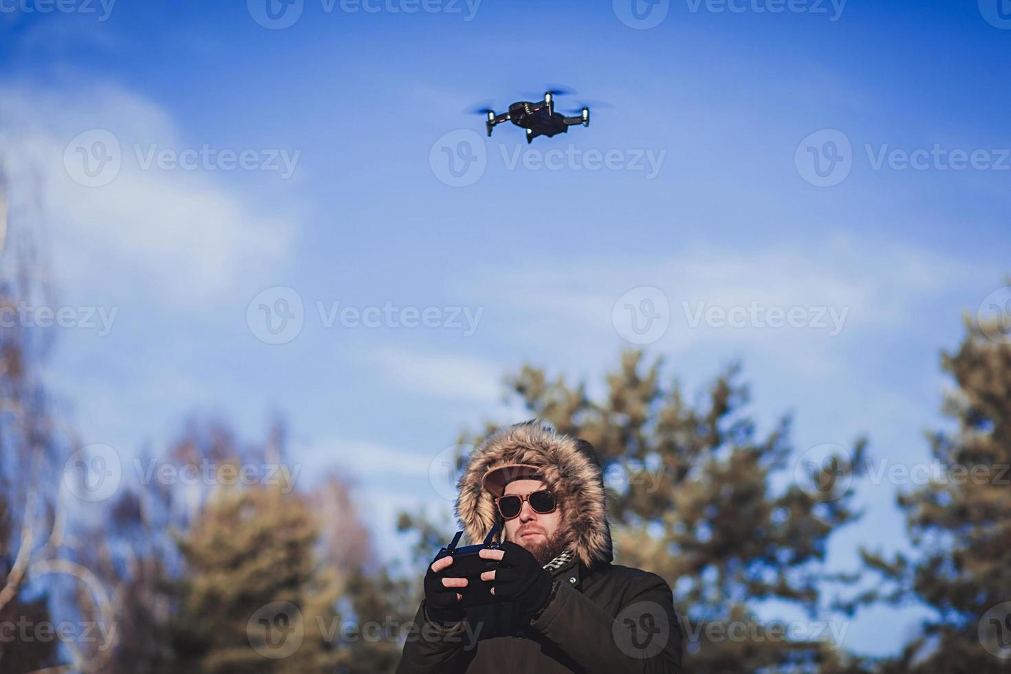 Bearded man playing with the drone photo