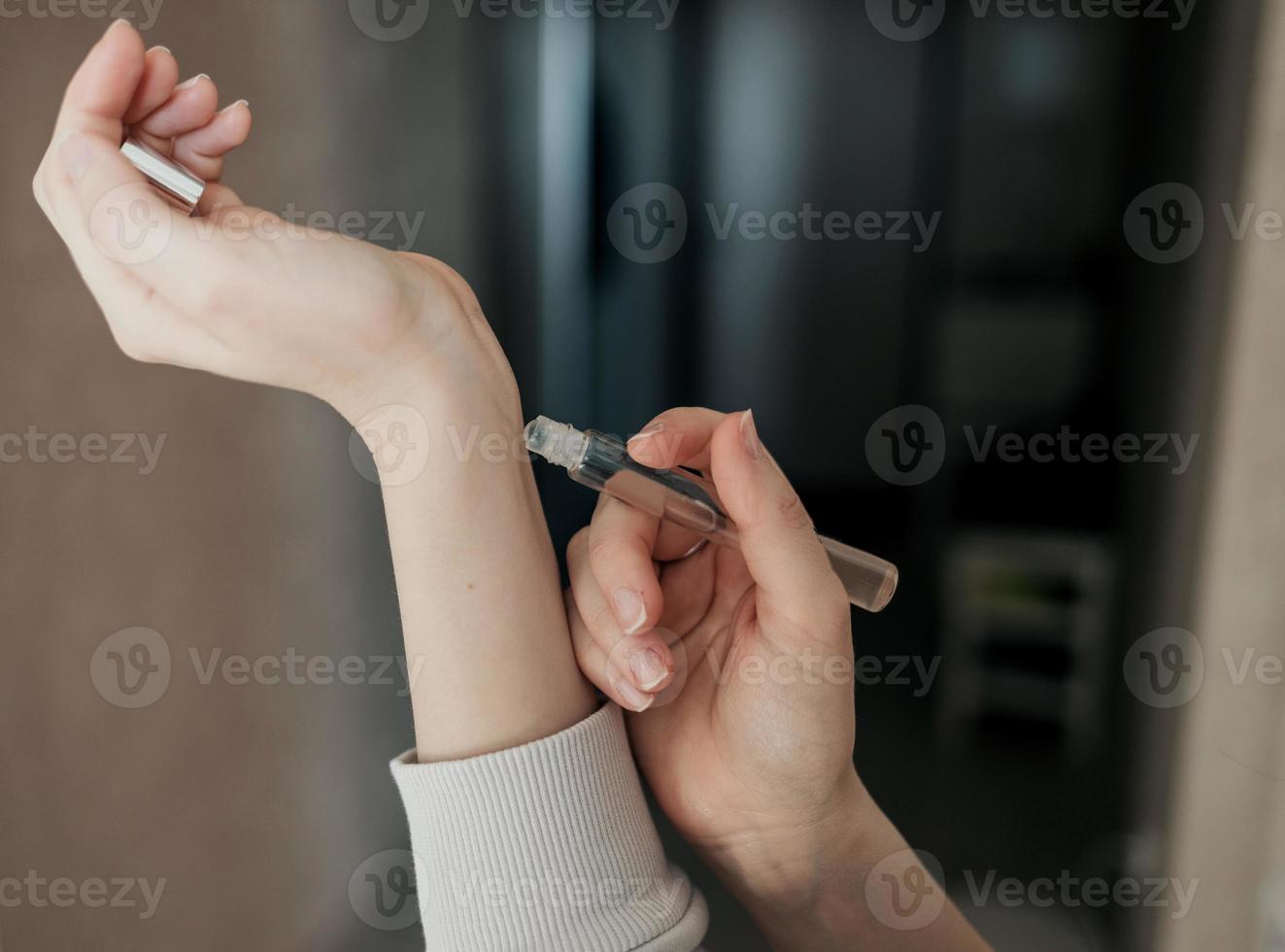 Woman applying essential oil photo