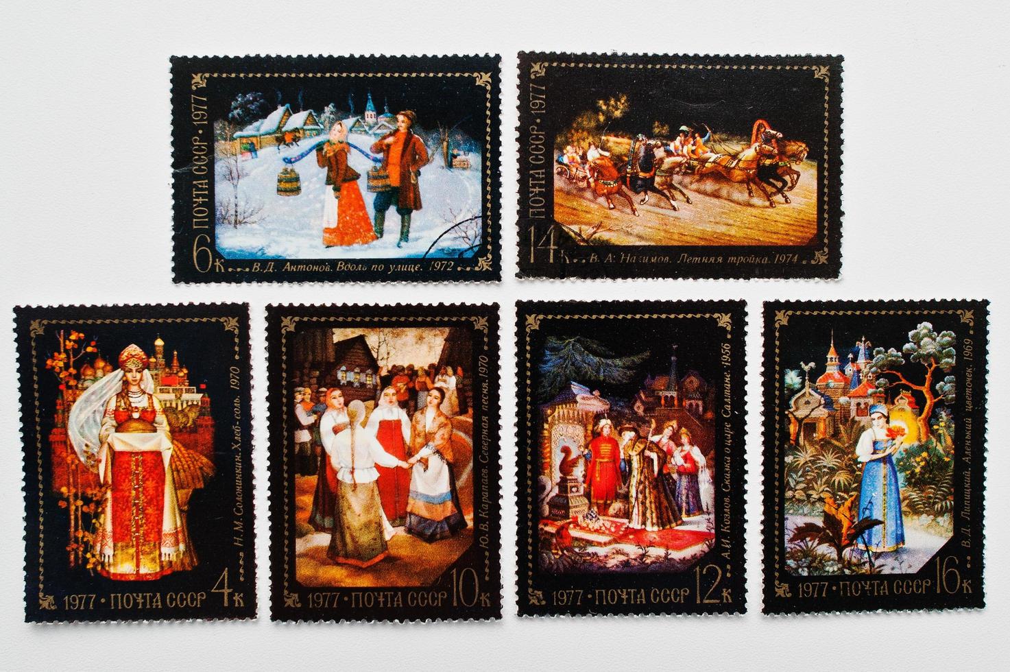 Collection of black postage stamps printed in USSR shows different russian tales, circa 1977 photo